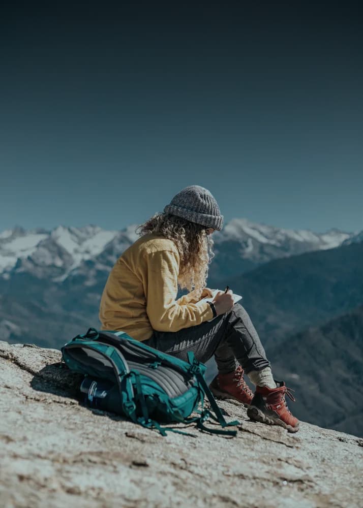 Hiker with backpack looking at mountains